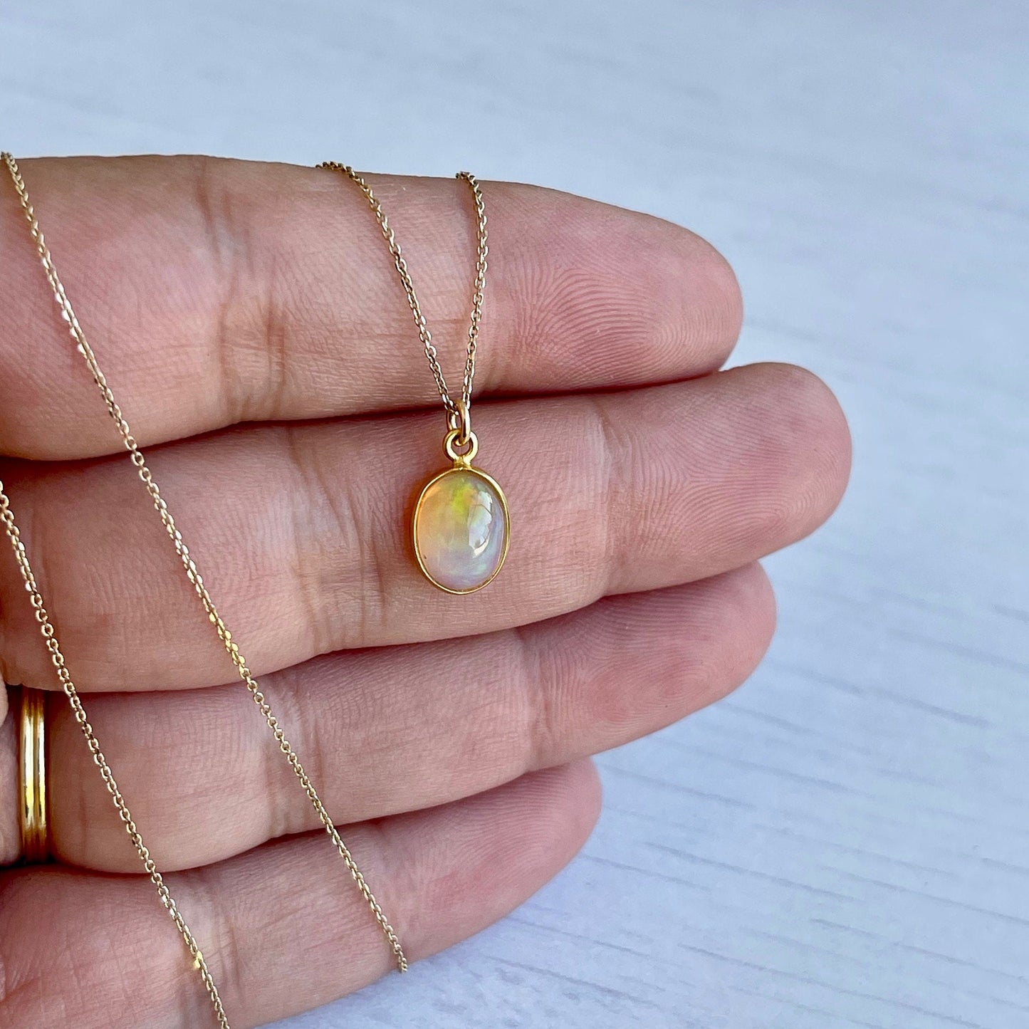 Tiny Ethiopian Opal Oval Pendant in Solid 14k Gold